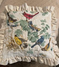 a decorative pillow with birds on it