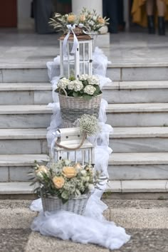 three baskets are stacked on top of each other in front of some steps with flowers