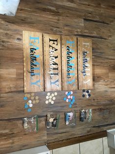 some wooden signs hanging on the side of a wall next to a stove top oven