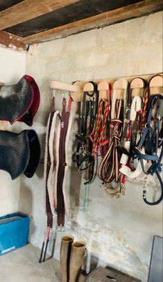 there are many pairs of boots hanging on the wall