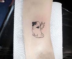 a small cat tattoo on the left arm and foot, with an angel wing flying above it