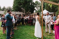 a bride and groom standing in front of an outdoor wedding ceremony