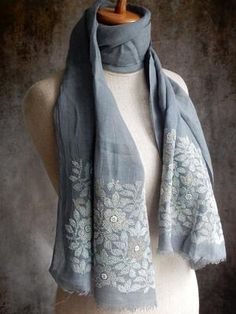 a gray scarf with white flowers on it