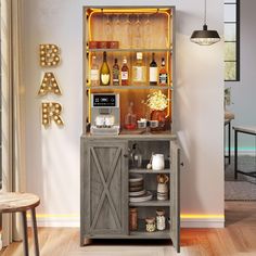 an open cabinet with bottles and glasses on it next to a wooden table in a living room