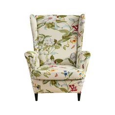 an upholstered chair with floral print on the back and arms, sitting in front of