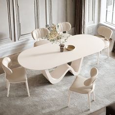 a white table with chairs around it in front of a window and a rug on the floor