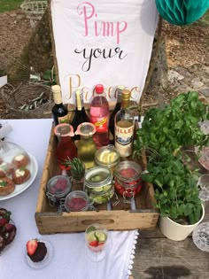 a wooden tray filled with drinks next to a sign