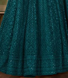 COLOR : Dark Teal Blue FABRIC : Top - Pure Georgette, Bottom & Inner - Santoon, Dupatta - Pure Georgette WORK : Heavy Silk Thread Embroidery, Heavy Sequin Work, Motifs, Lace BorderOCCASION : Wedding, Reception, Engagement, Party Wear, Festival READY-TO-WEAR : NoSTITCHING : Available as semi-stitched fabric, can be stitched using standard size option (+$20). Note: There might be a slight color variation due to lighting and flash used during photoshoot. The bright shade seen is the best closer vie Green Anarkali Suits, Indian Long Dress, Wedding Anarkali, Red Saree Wedding, Bridal Anarkali Suits, Bridal Anarkali, Onam Outfits, Silk Thread Embroidery, Colour Reference