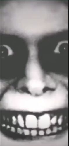 a black and white photo of a creepy clown's face