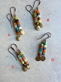 long stacked multi gemstone earrings   multicolor stack earrings * only one of each color pattern * small gemstone cubes - 4mm * all have red and light green aventurine along with other randomly selected and stacked gemstones * dangling below - an antiqued brass flat oval charm * antiqued brass hook ear wires * total length - 2" * you can enter my shop here: gypsydangles.etsy.com Bohemian Dangle Earrings With Faceted Beads, Earthy Handmade Beaded Dangle Earrings, Brown Dangle Earrings With Colorful Beads, Agate Gemstone Bead Dangle Earrings, Stack Earrings, Bohemian Multi-stone Dangle Earrings, Cube Earrings, Stacked Earrings, Brass Hook