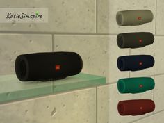 several different colored speakers hanging on the wall next to each other in front of a tiled wall