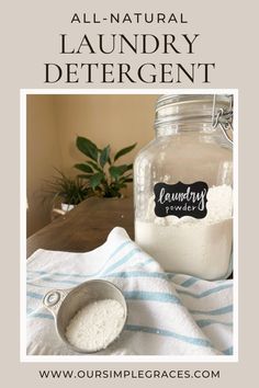 a glass jar filled with laundry deter next to a measuring spoon on top of a towel