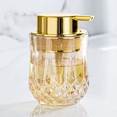 a glass jar with a gold lid sitting on a counter