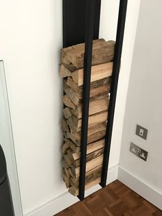 a stack of wood sitting on top of a hard wood floor next to a door