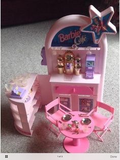 a pink barbie doll house with furniture and accessories