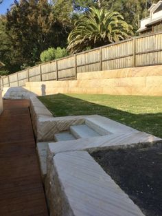 a wooden walkway in the middle of a yard