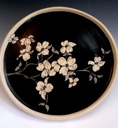 a black and white plate with flowers on it