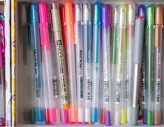 several pens are lined up in a drawer