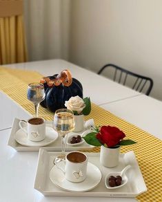 two white plates topped with cups and saucers