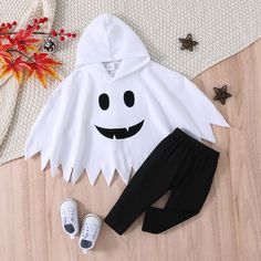 a child's halloween outfit with a ghost face on it