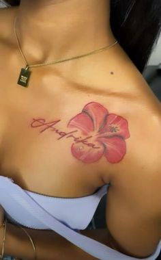 a close up of a woman's breast with a flower tattoo on her chest