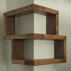 two wooden shelves on the wall with white walls