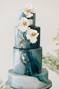 a blue marble cake with white flowers on top