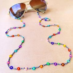 This handmade colorful daisy glasses chain is carefully hand-woven from the highest quality glass seed beads! It is not only a sunglasses chain, but also a multi-purpose glasses chain that you can use as a flower necklace wrap bracelet! Lenght 70 cm ( 27 inches ) All your clothes that you can use in every season are jewelery and accessories for matching women! Guaranteed to get all the compliments! You can click the link for other handmade jewelry and accessories! https://yasminjewelrygifts.etsy Diy Beaded Glasses Chain, Gift Colorful Glass Beads Glasses Chains, Seed Bead Glasses Chain, Sunglass Beaded Chain, Knitting Bracelet, Daisy Glasses, Glasses Necklace, Glasses Lanyard