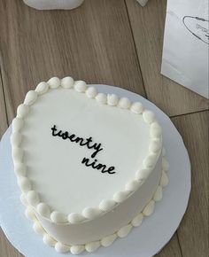 there is a white cake with the words twenty nine on it