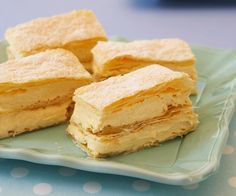 four pieces of cake sitting on top of a green plate