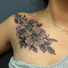 a woman with a flower tattoo on her chest