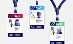 three id cards with lanyards attached to each one's neck and the other two