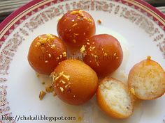 some oranges are sitting on a white plate