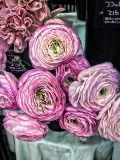 some pink flowers are sitting on a table