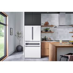 a white refrigerator freezer sitting inside of a kitchen next to a counter top oven