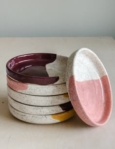 four ceramic dishes stacked on top of each other