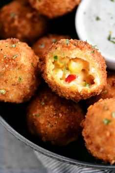 some fried food is in a bowl with dipping sauce