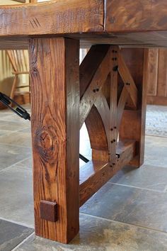 a wooden table sitting on top of a tile floor