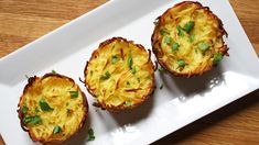 three mini quiches on a white plate