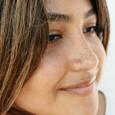 a close up of a woman with freckles on her face