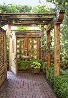 an open door leading into a lush green garden