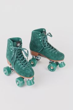 two green roller skates sitting on top of each other