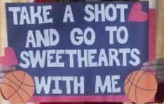 a woman holding up a sign that says take a shot and go to sweethearts with me