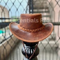 Introducing the Men's and Women's Genuine Leather Cowboy Outback Hat, a timeless piece inspired by vintage Australian Western style. This rugged yet stylish hat, adorned with antique bull conchos, is the perfect accessory for outdoor enthusiasts and those with a love for classic Western fashion. Crafted for both men and women, this hat combines durability with a distinctive, rustic charm. Product Description: Made from high-quality genuine leather, this Outback Cowboy Hat offers exceptional durability while maintaining a vintage, weathered look. The wide brim provides excellent sun protection, while the antique bull conchos add a unique, authentic touch to the design. Whether you're exploring the outdoors or dressing up for a Western-themed event, this hat delivers both style and functiona Vintage Distressed Brown Hat For Country Events, Vintage Rodeo Cap, Vintage Distressed Brown Hat For Rodeo, Vintage Leather Hats For Outdoors, Vintage Brown Hat For Ranch, Vintage Adjustable Hats For Country Events, Retro Brown Hat For Country Events, Classic Distressed Brown Hat For Outdoor, Classic Distressed Brown Hat With Short Brim