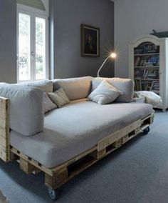 a couch made out of wooden pallets in a living room