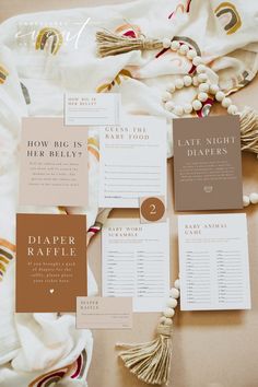 the wedding stationery is laid out on top of a blanket with tassels