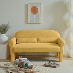 a yellow couch sitting on top of a white rug