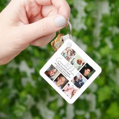 a person holding up a key chain with photos on it