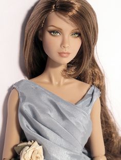 a doll is wearing a blue dress with flowers on the bottom and long hair in the middle