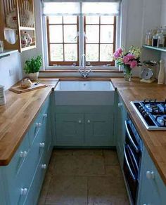 a kitchen with blue cabinets and wooden counter tops